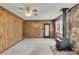 Spacious living room with wood-paneled walls, rustic wood-burning stove, and door to the backyard at 5921 Oak St, Hanahan, SC 29410