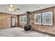 Cozy living room with wood-paneled walls, a vintage stove, and plenty of natural light at 5921 Oak St, Hanahan, SC 29410