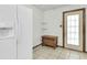 Mud room with white refrigerator, wood cabinet, door with window, and tiled floor at 5921 Oak St, Hanahan, SC 29410