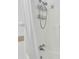 Detail of the shower stall featuring shower head with shower curtain and shelves at 5921 Oak St, Hanahan, SC 29410