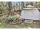 Charming backyard shed with double doors and surrounding garden area at 5921 Oak St, Hanahan, SC 29410