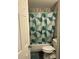 A view of a clean bathroom with a shower featuring decorative shower curtain and white fixtures at 6601 Dorchester Rd # 109, North Charleston, SC 29418
