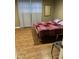 A well-lit bedroom with wood floors, a large window, and neutral walls at 6601 Dorchester Rd # 109, North Charleston, SC 29418