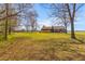 Sprawling backyard features lush greenery, mature trees, and a charming home with a porch at 729 2Nd Bend Rd, Harleyville, SC 29448