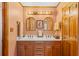 Well-lit bathroom boasts a double vanity, wood cabinets, and attractive matching mirrors at 729 2Nd Bend Rd, Harleyville, SC 29448