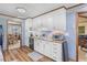 Efficient kitchen design with bright white cabinetry and views of the dining area at 729 2Nd Bend Rd, Harleyville, SC 29448