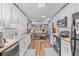 Open kitchen with white cabinets, center island and view to dining area at 729 2Nd Bend Rd, Harleyville, SC 29448