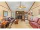 Warm living room features a cozy brick fireplace, plush seating, and inviting decor at 729 2Nd Bend Rd, Harleyville, SC 29448