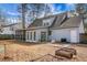 Home's backyard with screened porch, multiple doors, and garden beds at 8458 William Moultrie Dr, North Charleston, SC 29420