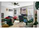 Bright bedroom with ceiling fan, comfortable seating, and ample natural light from the windows at 8458 William Moultrie Dr, North Charleston, SC 29420