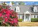 Charming two-story home with blooming shrubbery accenting the manicured front lawn at 8458 William Moultrie Dr, North Charleston, SC 29420