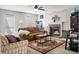 Warm and inviting living room featuring a fireplace, comfortable seating, and a ceiling fan at 8458 William Moultrie Dr, North Charleston, SC 29420