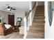 Cozy living room with staircase, comfortable seating, and natural light from the front door at 8458 William Moultrie Dr, North Charleston, SC 29420