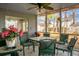 Enclosed patio with a table, chairs, ceiling fan, and view of the backyard at 8458 William Moultrie Dr, North Charleston, SC 29420