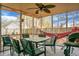 Enclosed patio with a table, chairs, hammock, ceiling fan, and view of the backyard at 8458 William Moultrie Dr, North Charleston, SC 29420