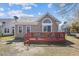 Exterior backyard view with deck, lawn, and home, perfect for outdoor enjoyment and relaxation at 9021 Delancey Cir, North Charleston, SC 29406