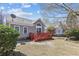 View of backyard featuring a deck, lawn, and home exterior, offering a relaxed outdoor lifestyle at 9021 Delancey Cir, North Charleston, SC 29406