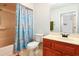 Bathroom features a blue floral shower curtain, vanity and a mirror at 9021 Delancey Cir, North Charleston, SC 29406