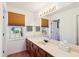 Well-lit bathroom with wood cabinets, and a large mirror at 9021 Delancey Cir, North Charleston, SC 29406