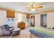 Inviting bedroom features carpet, ceiling fan, and a cozy sitting area at 9021 Delancey Cir, North Charleston, SC 29406