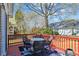 Cozy outdoor deck with table, chairs, and red railing, creating a charming space to unwind at 9021 Delancey Cir, North Charleston, SC 29406