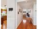 Open hallway with hardwood floors leading to the kitchen and living room area at 9021 Delancey Cir, North Charleston, SC 29406