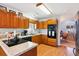 Well-equipped kitchen with wood cabinets, granite countertops, and modern appliances at 9021 Delancey Cir, North Charleston, SC 29406