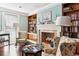 Inviting library showcasing a fireplace, hardwood floors, and comfortable seating at 9021 Delancey Cir, North Charleston, SC 29406