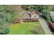 Stunning aerial view of a brick home with lush lawn, mature trees, and a sparkling pool, offering a private and serene oasis at 958 Mikell Dr, Charleston, SC 29412