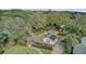 Sweeping aerial shot of a beautiful home with a well-manicured lawn and inviting pool nestled among trees, perfect for outdoor living at 958 Mikell Dr, Charleston, SC 29412