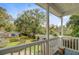 Scenic view from balcony showcasing a large backyard with mature trees and a detached building at 958 Mikell Dr, Charleston, SC 29412