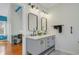 Bright bathroom features double vanity with marble countertop and modern fixtures and mirrors at 958 Mikell Dr, Charleston, SC 29412