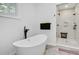 Elegant bathroom boasts a freestanding tub, rainfall shower, and sleek, modern fixtures at 958 Mikell Dr, Charleston, SC 29412
