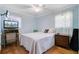Comfortable bedroom with a soft bed, mounted TV and hardwood floors at 958 Mikell Dr, Charleston, SC 29412