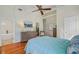 Bright bedroom with hardwood floors, a ceiling fan, and ensuite access at 958 Mikell Dr, Charleston, SC 29412