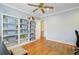 Well-lit bedroom featuring hardwood floors and built-in storage shelves at 958 Mikell Dr, Charleston, SC 29412