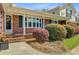 Cozy front porch with brick accents and manicured landscaping, creating a warm and inviting curb appeal at 958 Mikell Dr, Charleston, SC 29412