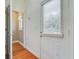 Bright hallway with hardwood floors and a windowed door leading to the outside at 958 Mikell Dr, Charleston, SC 29412