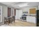 Eat-in kitchen features light wood floors, stainless steel appliances, and breakfast nook at 958 Mikell Dr, Charleston, SC 29412