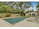 Backyard pool area with lounge chairs, mature trees, and a well-maintained lawn at 958 Mikell Dr, Charleston, SC 29412