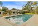 Outdoor pool area with lounge chairs, mature trees, and view of the two-story home at 958 Mikell Dr, Charleston, SC 29412