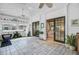 Bright sun room with tiled floors, ceiling fans, neutral decor, and multiple sliding glass doors at 958 Mikell Dr, Charleston, SC 29412