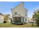 Back exterior view of home with screened in porch and trampoline with a large backyard at 103 Avalon Ct, Goose Creek, SC 29445