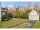 Spacious backyard featuring a detached garage, trampoline, green grass, and a screened-in porch at 103 Avalon Ct, Goose Creek, SC 29445