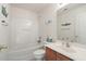 This white bathroom features a combined shower and tub and a sink with a dark wooden vanity at 103 Avalon Ct, Goose Creek, SC 29445