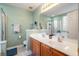 This bathroom features a double sink vanity, large mirror, and a door leading to the toilet at 103 Avalon Ct, Goose Creek, SC 29445