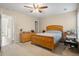 This bedroom features a ceiling fan, light-colored walls, and an adjoining door to the bathroom and closet at 103 Avalon Ct, Goose Creek, SC 29445