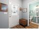 Inviting entryway featuring wood floors, a decorative door, and a glimpse into a half-bathroom with stylish decor at 103 Avalon Ct, Goose Creek, SC 29445