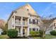 Charming two-story home with a covered porch, white pillars, manicured landscaping, and neutral siding against a blue sky at 103 Avalon Ct, Goose Creek, SC 29445