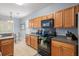 Cozy kitchen with wood cabinetry, appliances, and view into the dining area for easy meal preparation and serving at 103 Avalon Ct, Goose Creek, SC 29445
